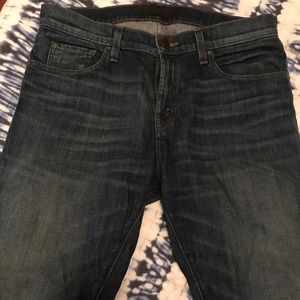 J Brand slim straight jeans in dark blue.